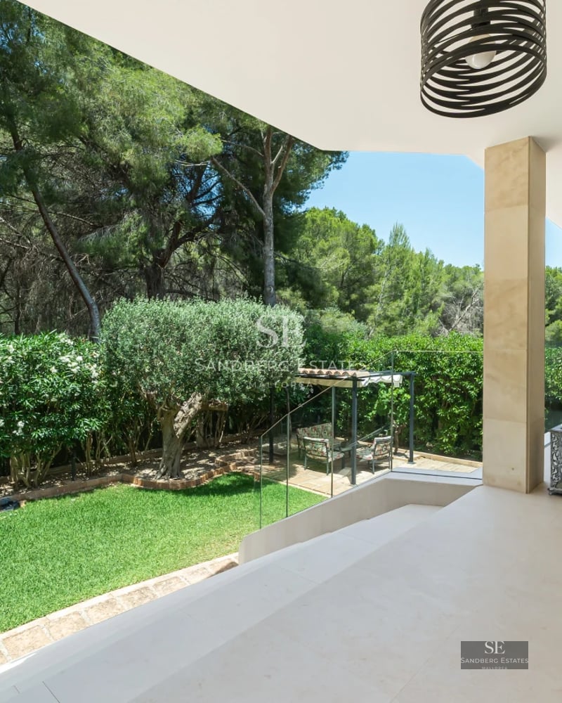 Spacious, bright living room with large windows and panoramic sea views. Modern sofa and elegant decor.