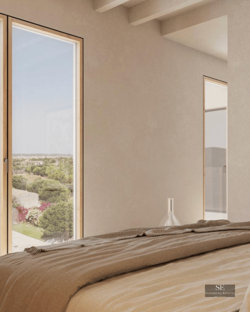 Minimalist bedroom featuring a large window with field views, exposed wood beams, and neutral beige tones.
