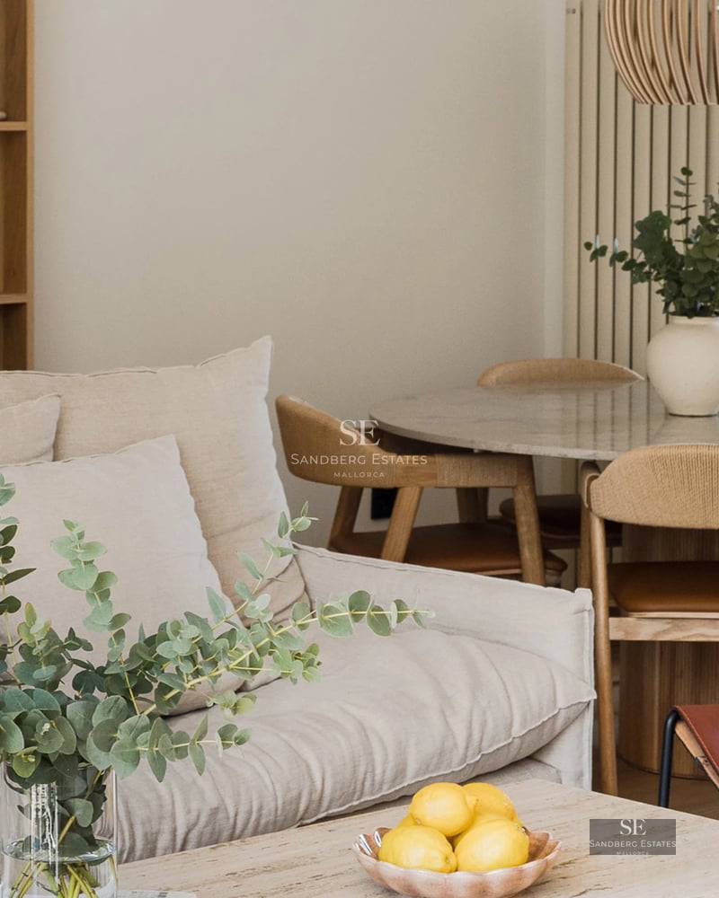 View of modern villa with infinity pool, manicured garden, and minimalist facade. Soft ambient lighting and blue sky.