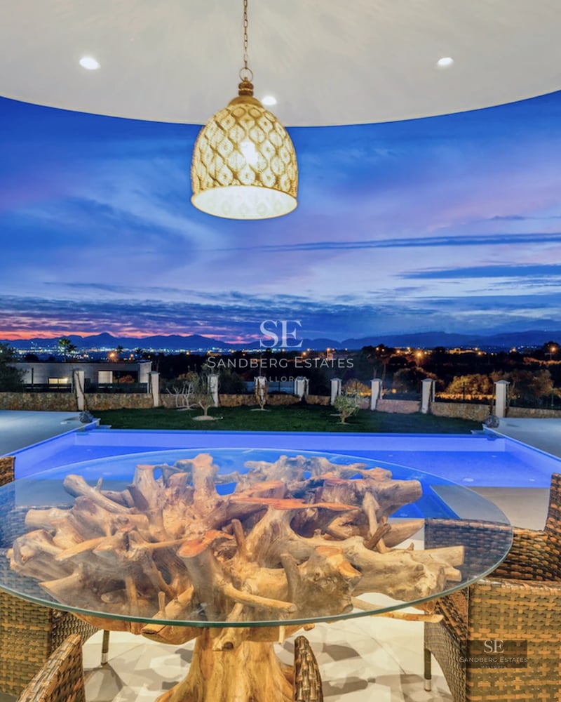 Panoramic view of a modern pool with terrace, sun loungers, and lush vegetation. Minimalist architectural design and luxury finishes.
