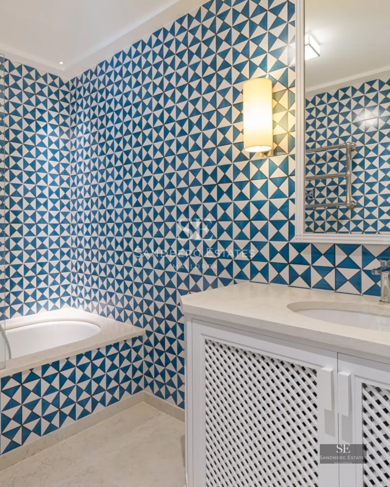 Expansive terrace featuring an infinity pool and sea views. Modern furniture, sun loungers and parasols. Elegant and relaxing design.