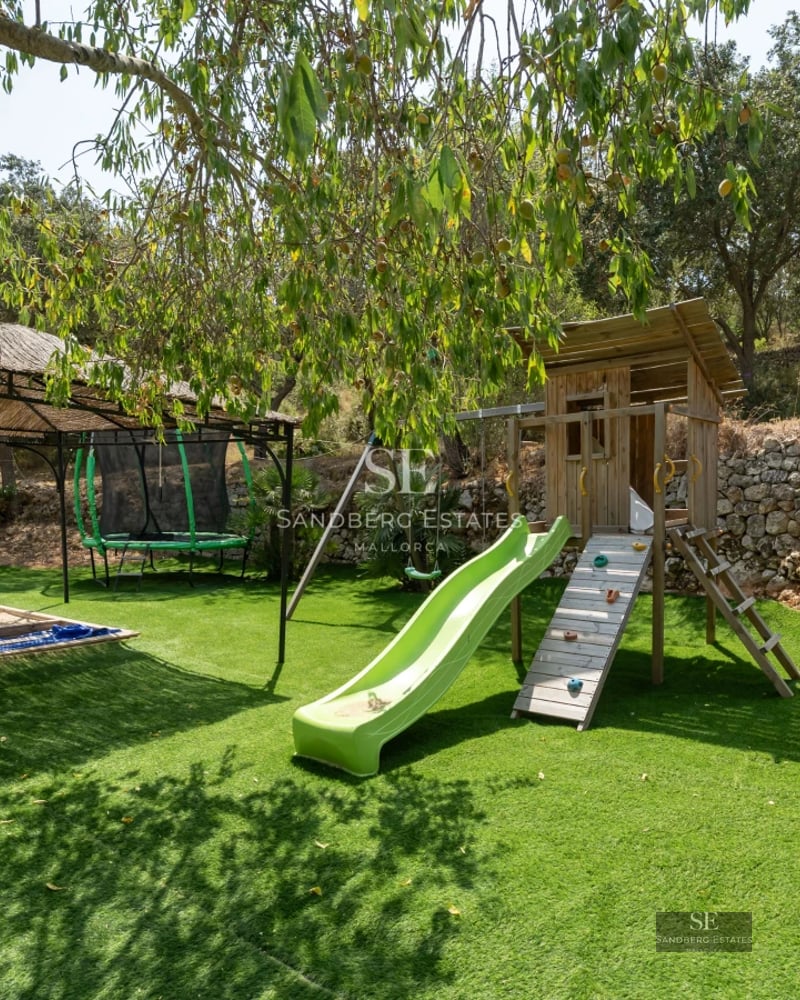 Aerial view of a modern villa featuring an infinity pool, lush garden, and minimalist design. Warm lighting and luxury finishes.