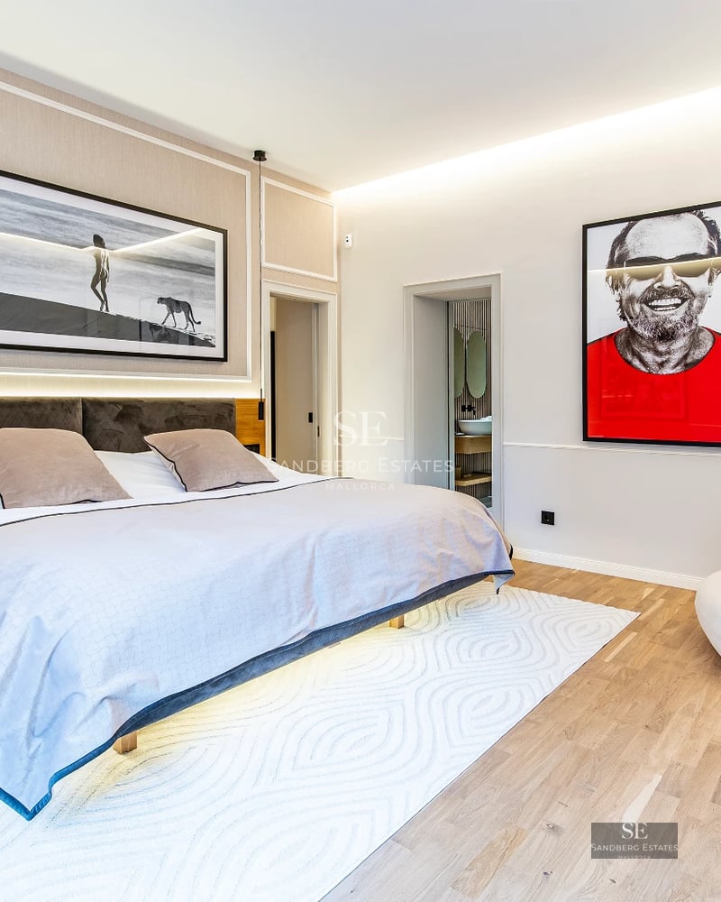 Spacious living room with balcony and ocean view. Light wood floors, white walls and modern furniture in neutral tones.