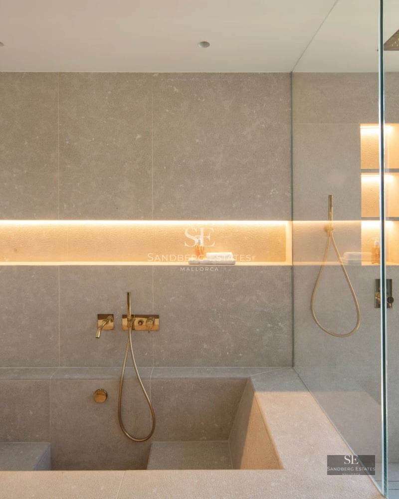 Bright living room with fireplace and balcony access with views. Modern design, wood floors, neutral colors. Large windows.