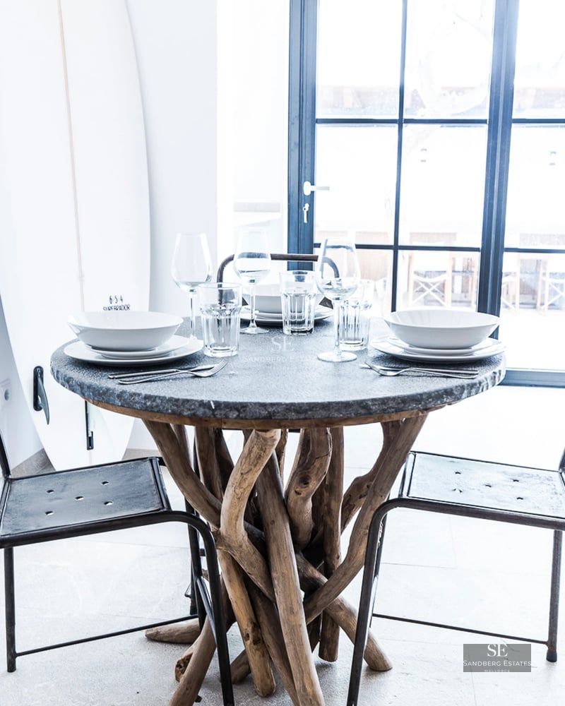 Spacious terrace with infinity pool, sun loungers, and panoramic views. Modern design featuring glass railing and lush greenery.