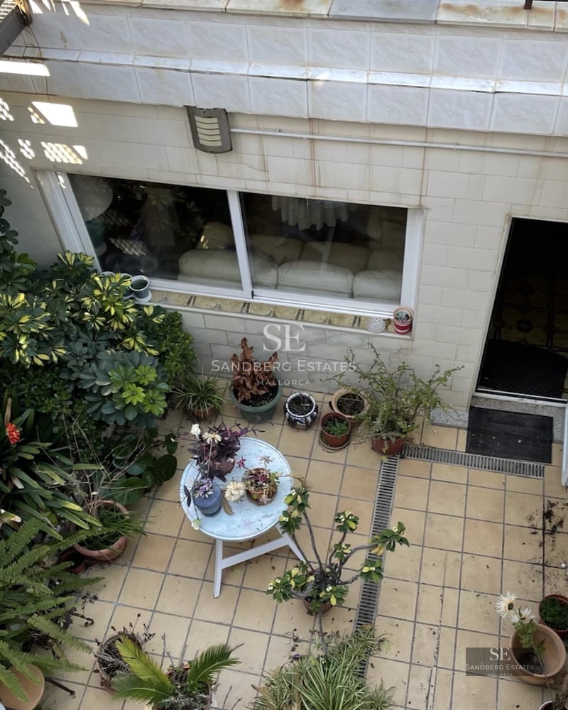Exterior view of modern villa featuring an infinity pool, lush garden, and minimalist architecture. Warm ambient lighting.