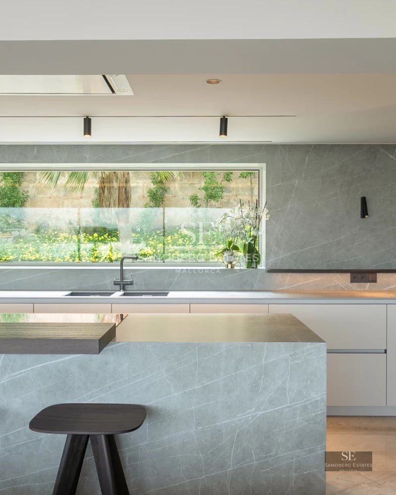 View of a luxurious villa with a pool. Modern design, large windows, lush garden and elegant outdoor furniture.