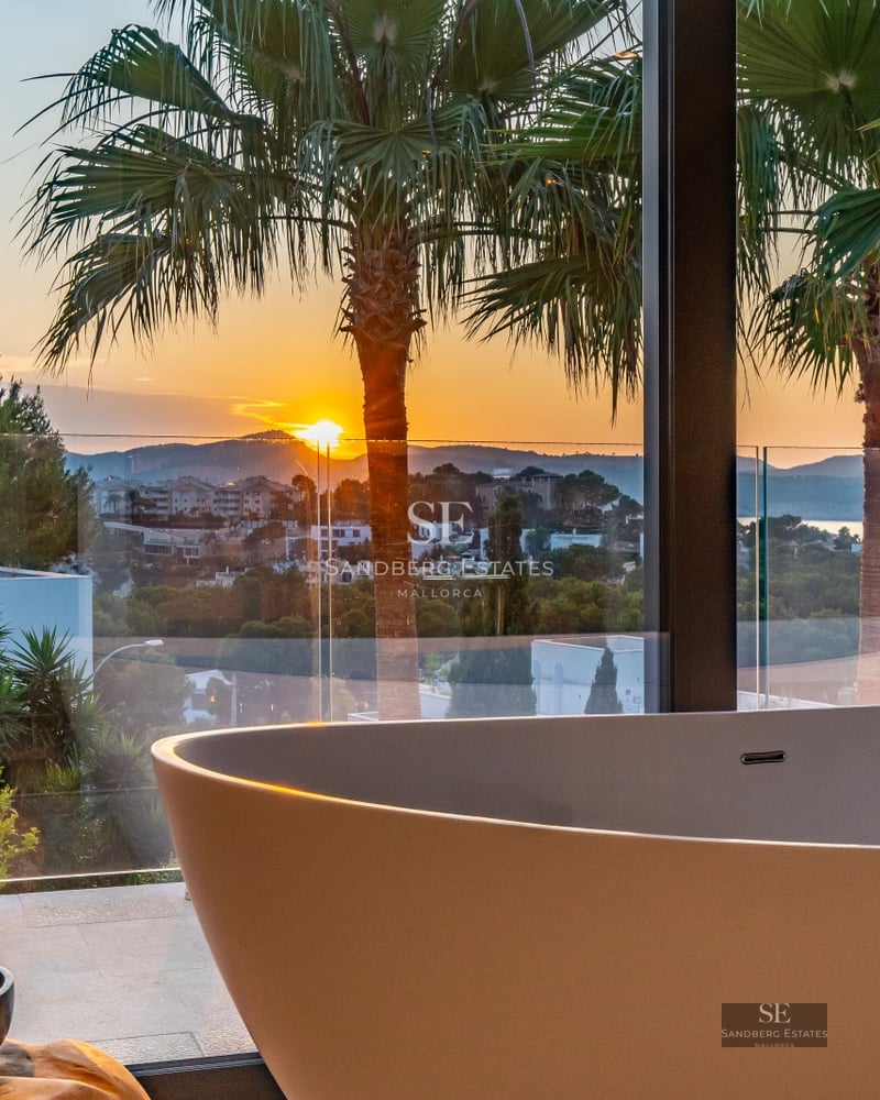 Modern villa exterior featuring a pool, surrounded by greenery. Minimalist architecture with large windows and high-end materials.