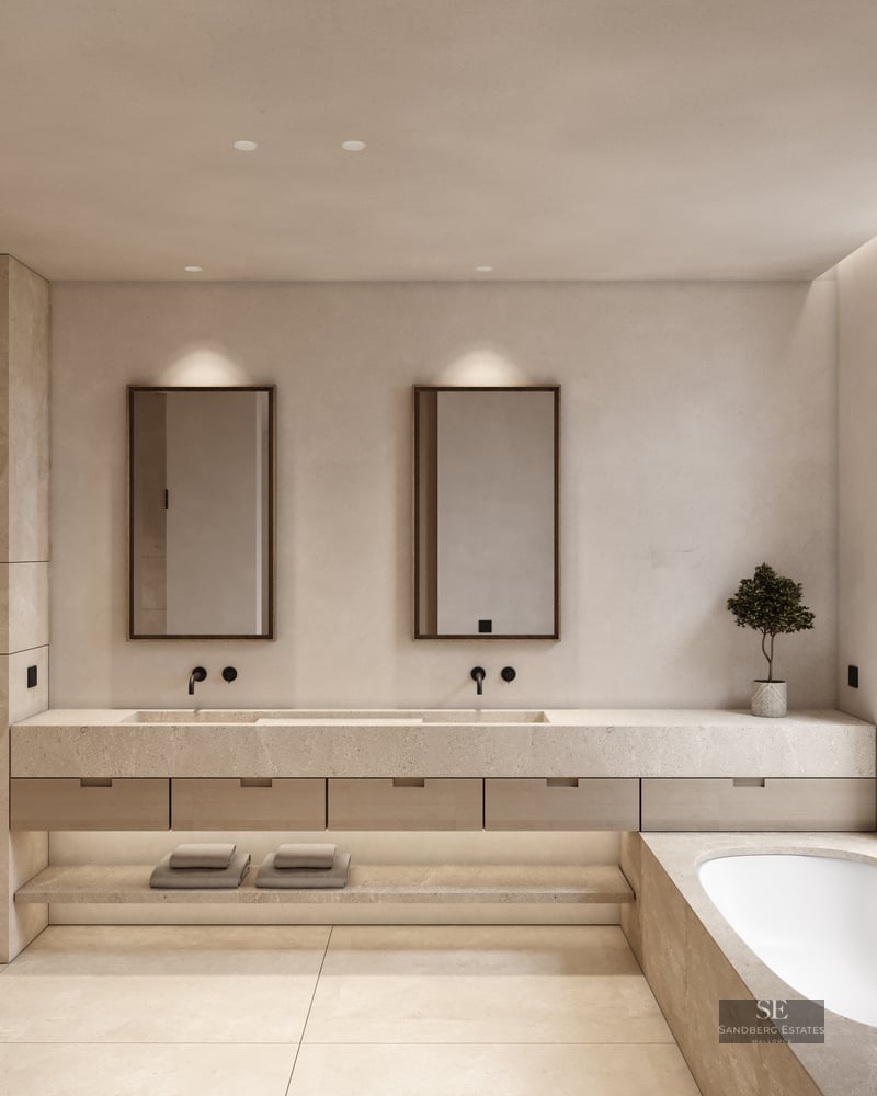 Luxury bathroom with double stone vanity, built-in tub, and large window with natural light.