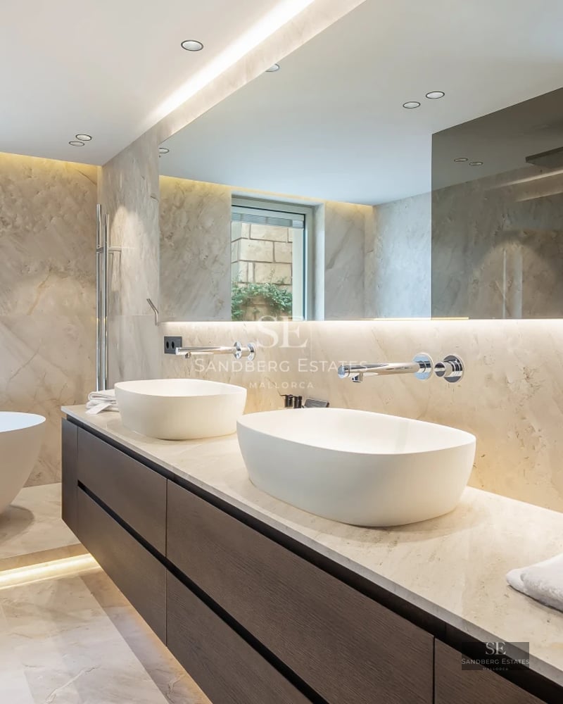 Balcony view featuring a glass railing, infinity pool, and panoramic ocean views. Modern and minimalist furniture. Bright and spacious.