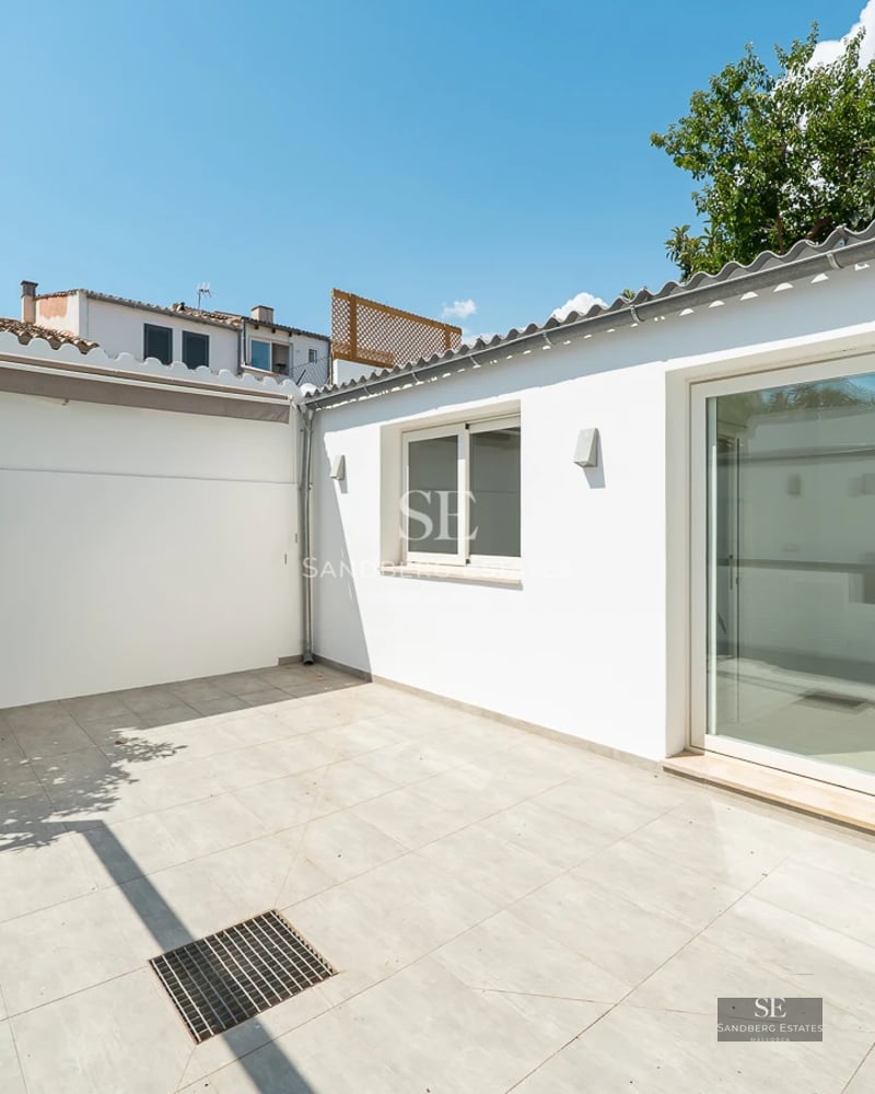 View of a modern villa featuring an infinity pool, sun loungers, and expansive garden. Minimalist architecture, perfect for relaxation.