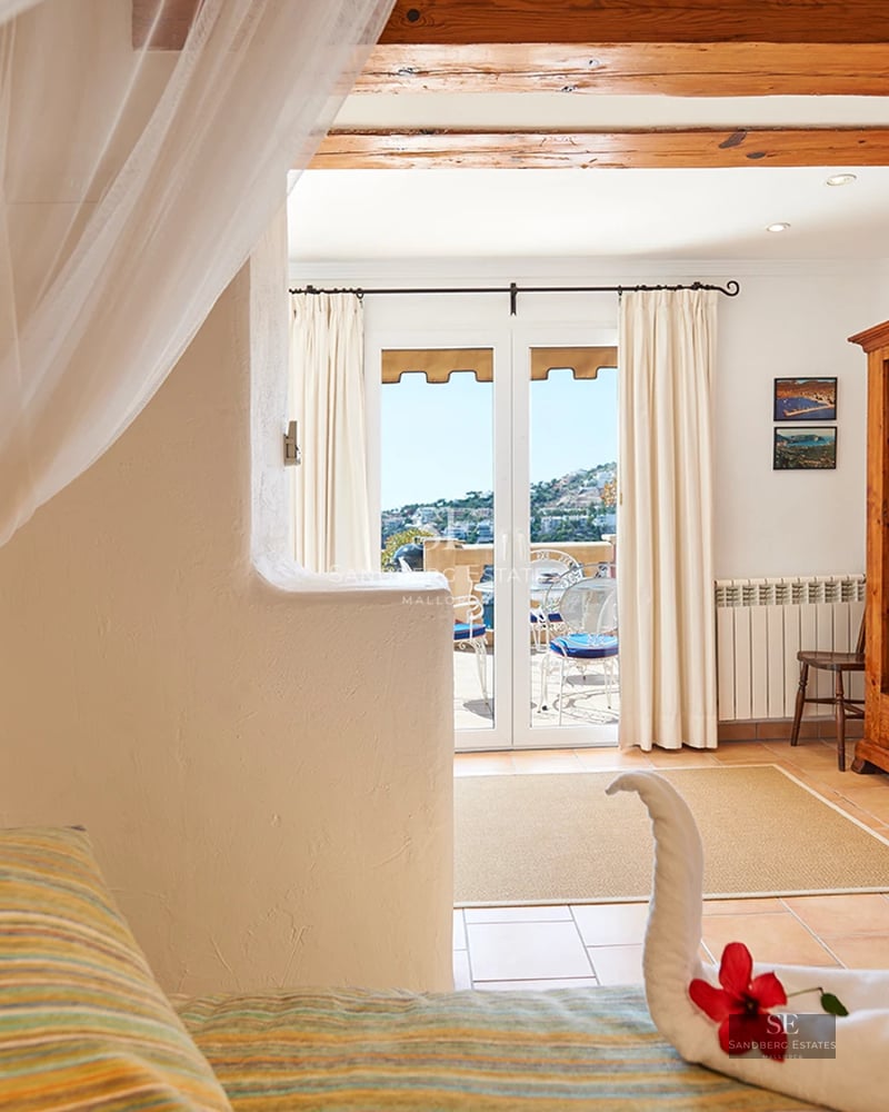 Modern apartment with sea view balcony. Stylish outdoor furniture. Minimalist design with abundant natural light.