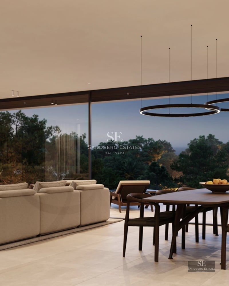 Large pool bordered by an elegant terrace with sun loungers. Modern architecture with large windows and lush vegetation.