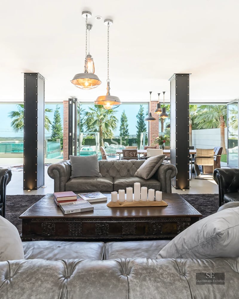 Panoramic view of a modern villa with a swimming pool, garden and large terraces. Minimalist architecture with clean lines and abundant natural light.