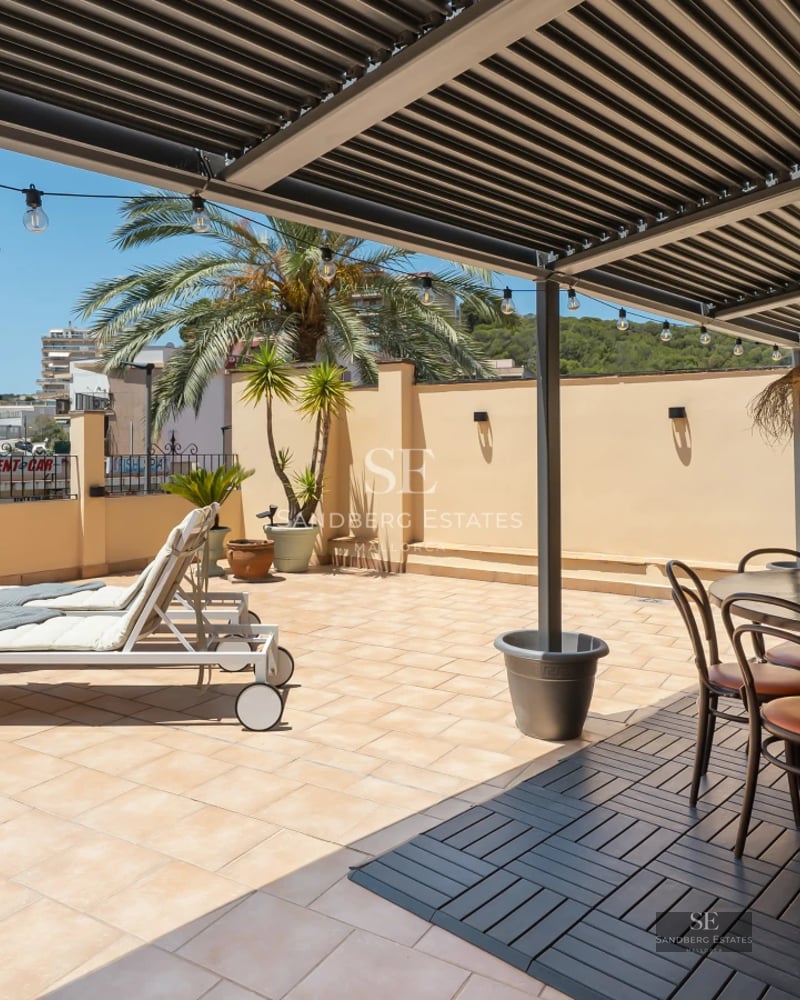 Spacious pool surrounded by lush garden. Modern architecture, warm lights, and stylish outdoor furniture.