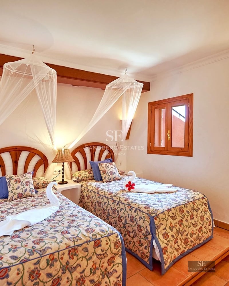 Modern terrace with sea view. Glass railing, minimalist outdoor furniture, and wooden flooring. Bright and spacious.