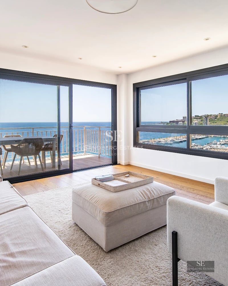 Aerial view of luxurious villa with infinity pool, lush garden, and modern design. Expansive terraces and high-quality finishes.