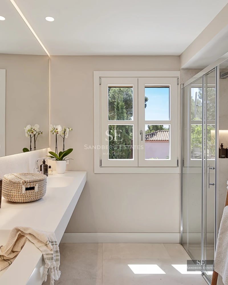 Spacious balcony with sea view, modern furniture and wooden flooring. Glass railing maximizes panoramic views.