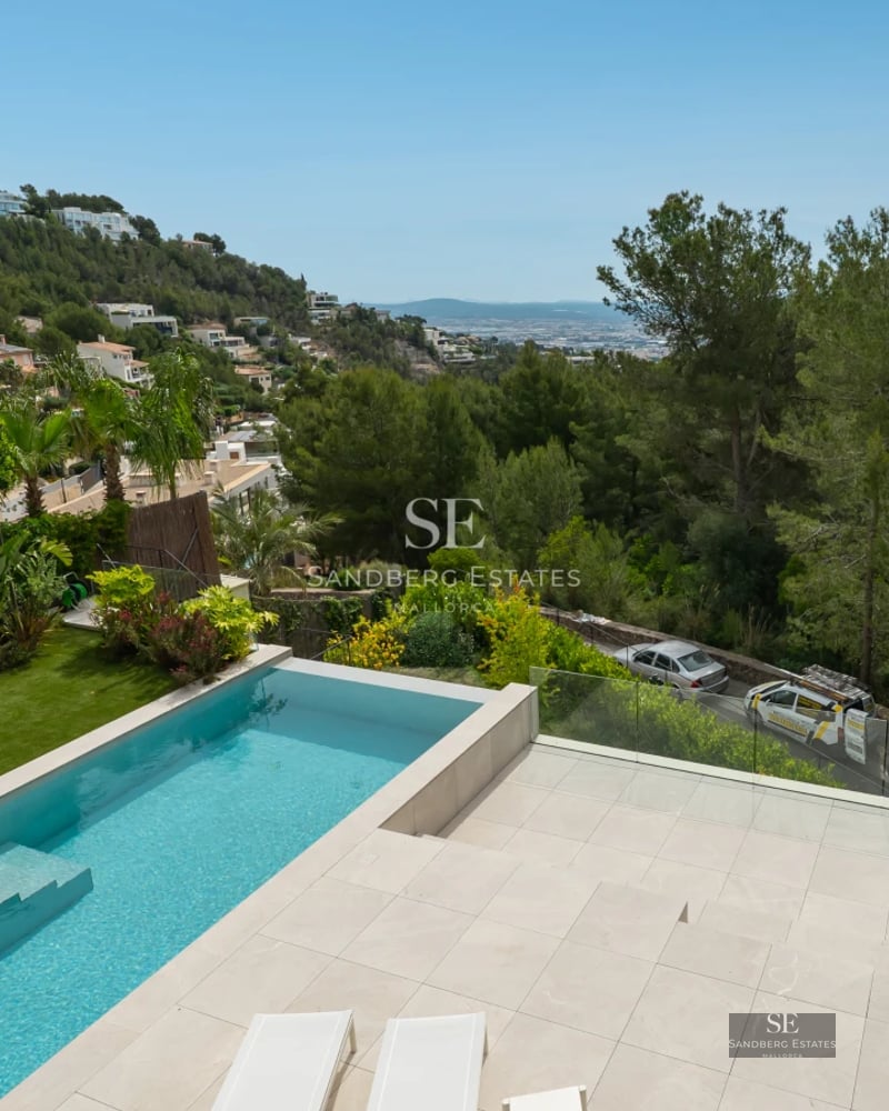 Expansive terrace featuring an infinity pool, sun loungers, and panoramic views. Modern design with clean lines and high-quality materials.