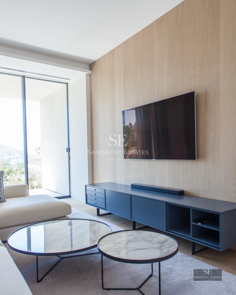 View of infinity pool with sun loungers, palm trees, and clean-lined modern architecture. Minimalist design with wood accents.