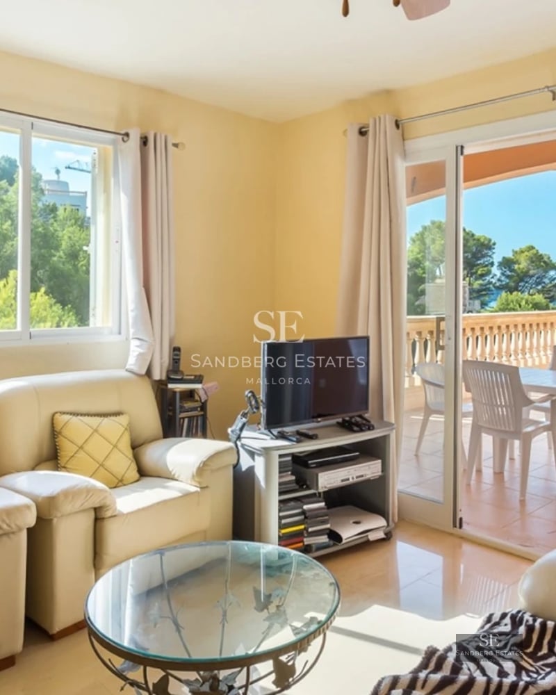 Bright interior with large windows, light wood flooring, and modern furniture. Panoramic sea views.