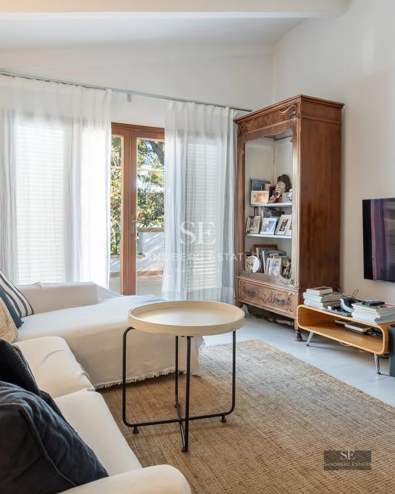 Image of an infinity pool with ocean view. Modern design with lounge chairs and lush gardens.