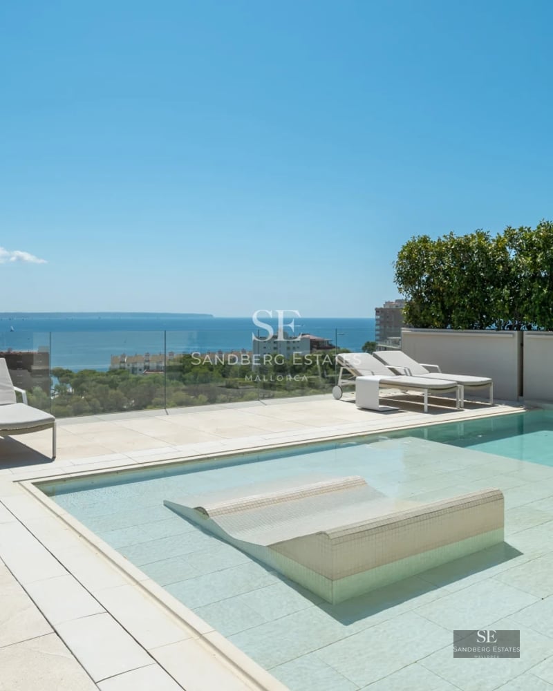 Exterior view of a modern villa with reflecting pool, minimalist garden, and large glass windows. Contemporary design.