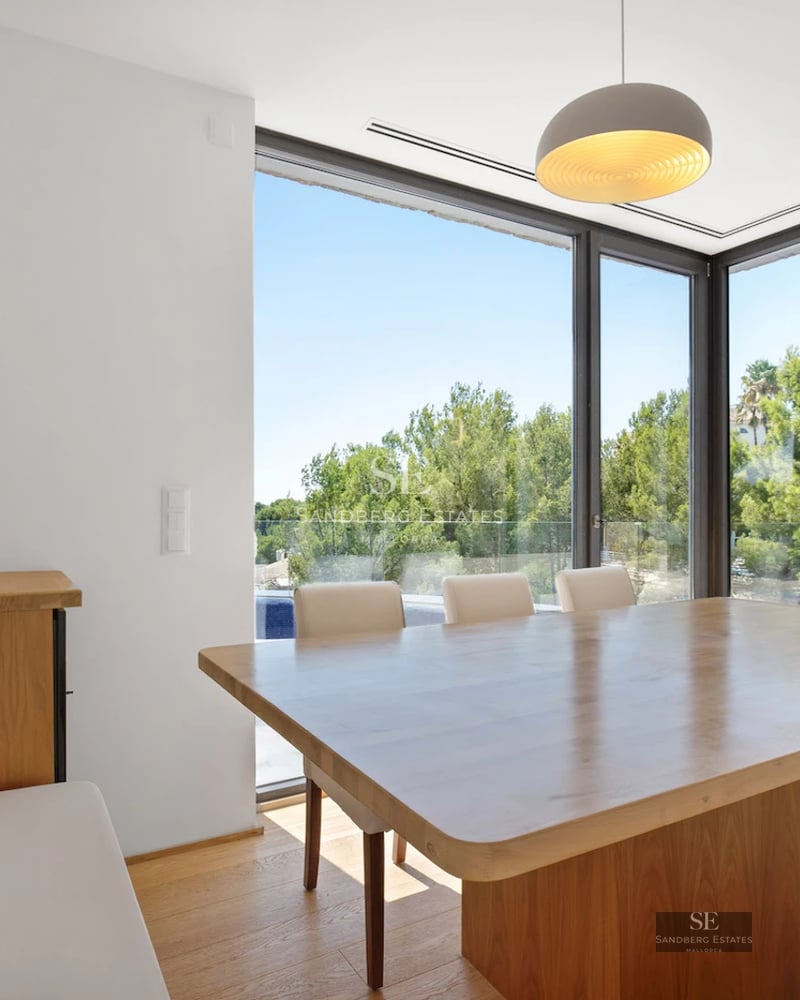 Exterior of a modern villa featuring an infinity pool, lush gardens, and expansive terraces. Elegant architecture and panoramic views.