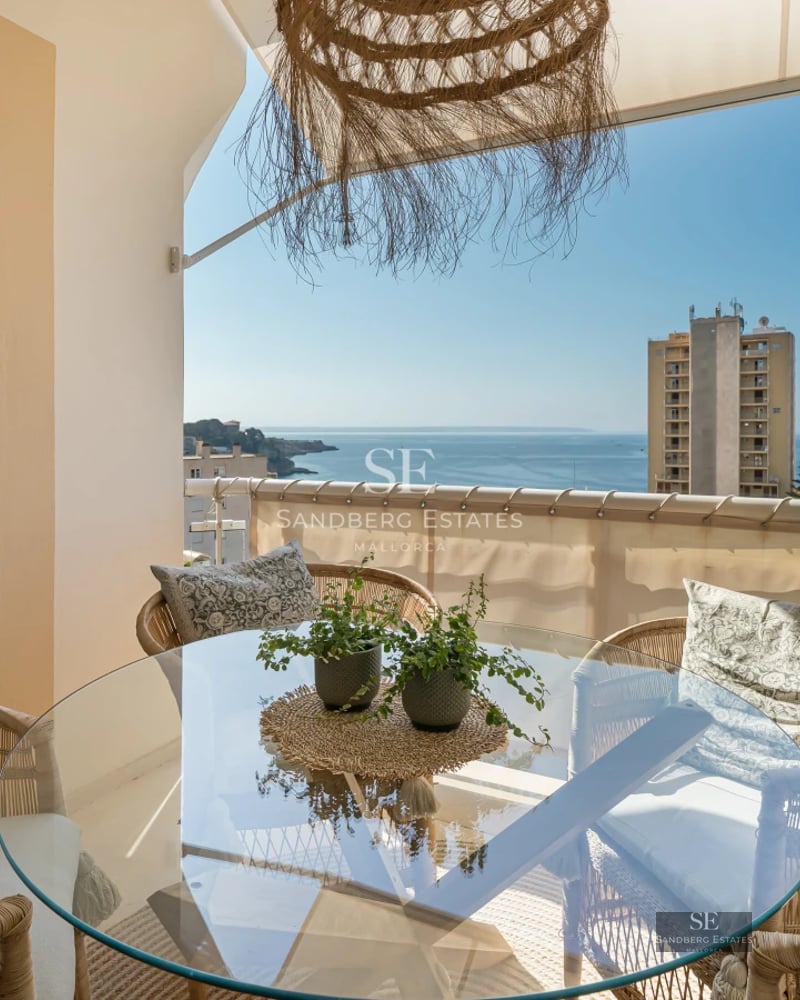 Large infinity pool surrounded by green lawn and sun loungers. Modern architecture with large windows. Luxurious and relaxing outdoor space.