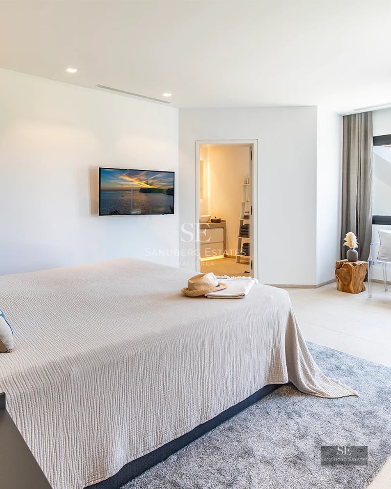 Spacious balcony with sea view, modern furniture, glass railing, wooden floor, perfect for enjoying the outdoors.