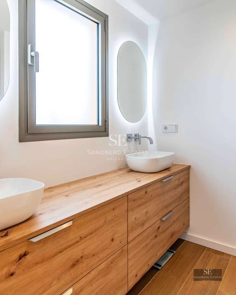 Exterior view of a modern villa featuring a pool, large windows, lush garden, and high-quality finishes.