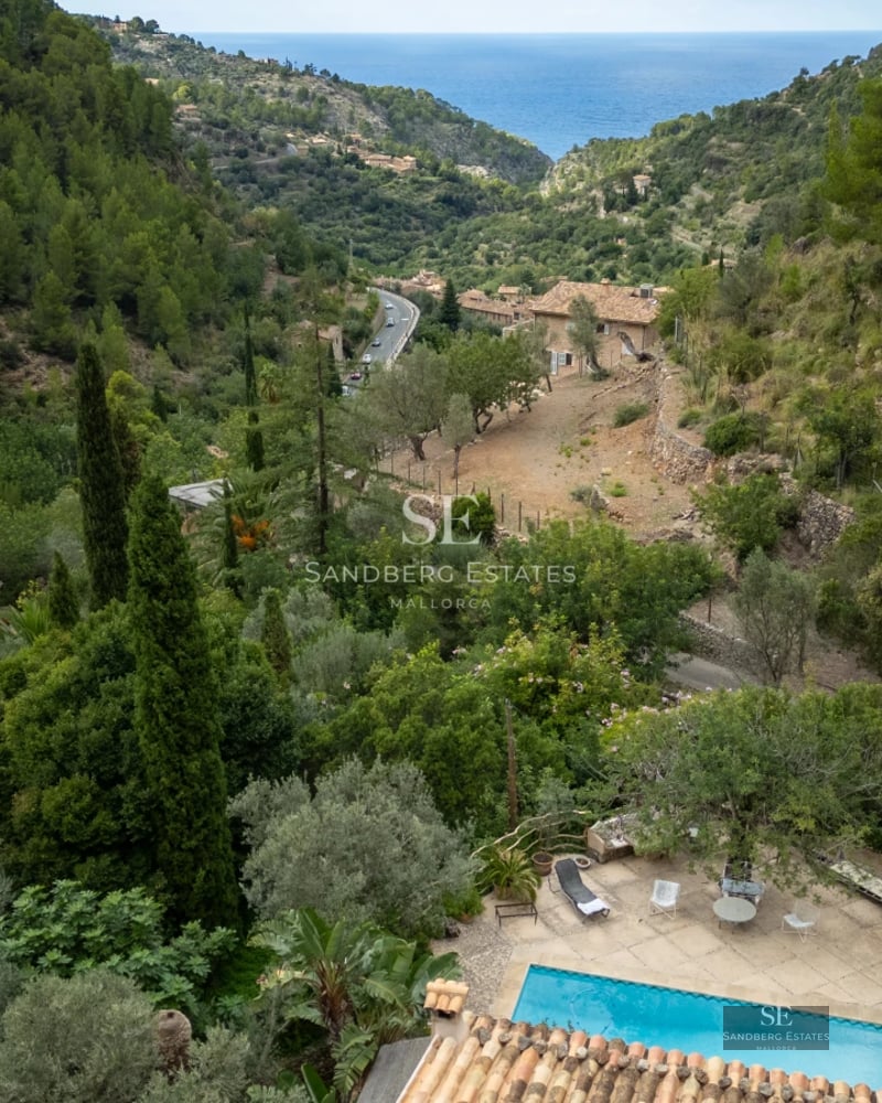 Exterior view of a modern villa with a pool and lush greenery. Contemporary architecture and landscape design.
