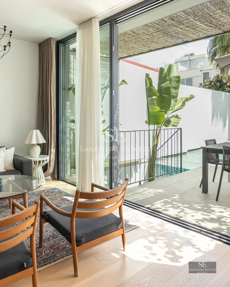 Exterior view of a modern villa with infinity pool, lush garden, and sleek architectural design. Soft ambient lighting.