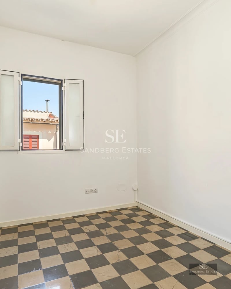 Panoramic view of furnished balcony overlooking the sea with modern outdoor furniture including table, chairs, and awning.