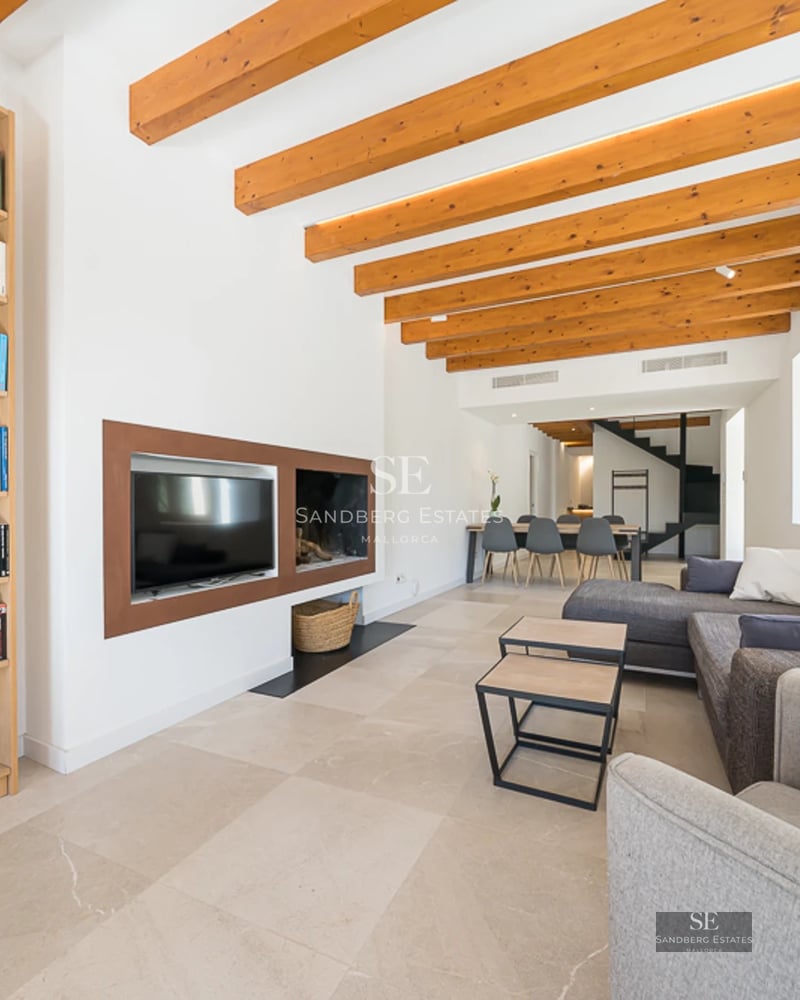 Exterior view of a modern villa with blue pool, surrounded by greenery and large windows. Minimalist architecture.