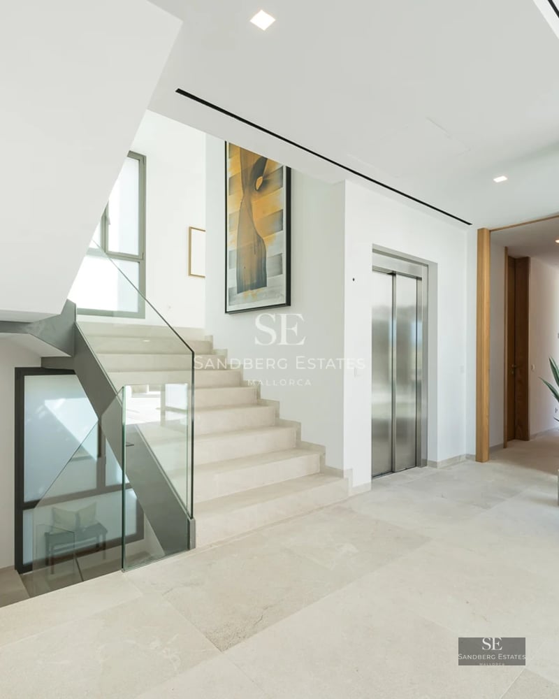 View of infinity pool with stone border, sun loungers and sea view. Modern and elegant design, ideal for relaxation and enjoyment.