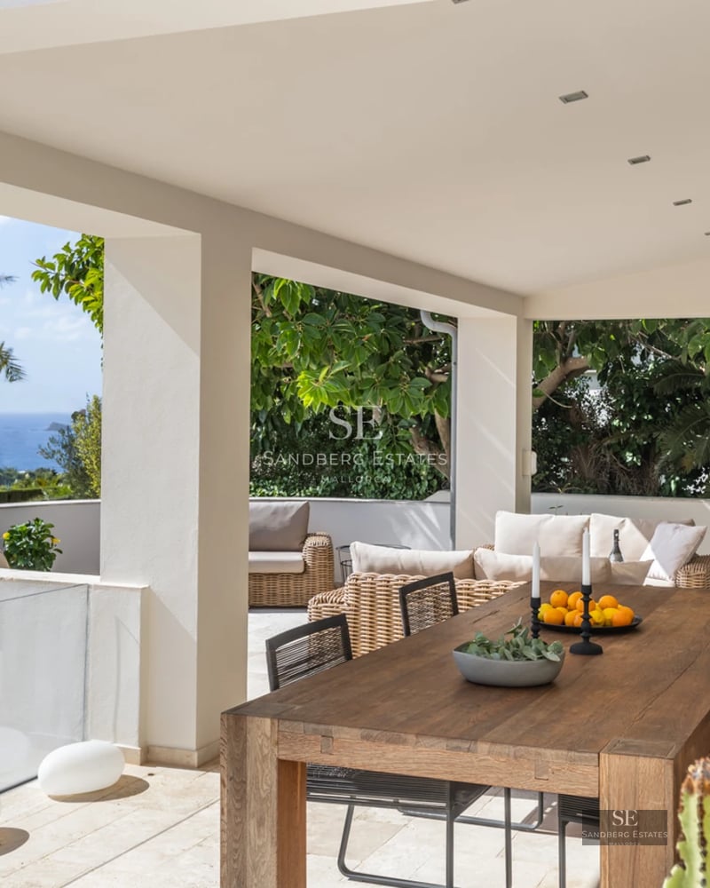 Expansive terrace with infinity pool and panoramic views. Modern design featuring wood flooring, sun loungers, and minimalist architecture.