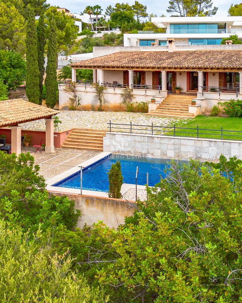 Modern exterior featuring an infinity pool, sleek loungers, and lush garden. Minimalist design, clean lines, and expansive views.