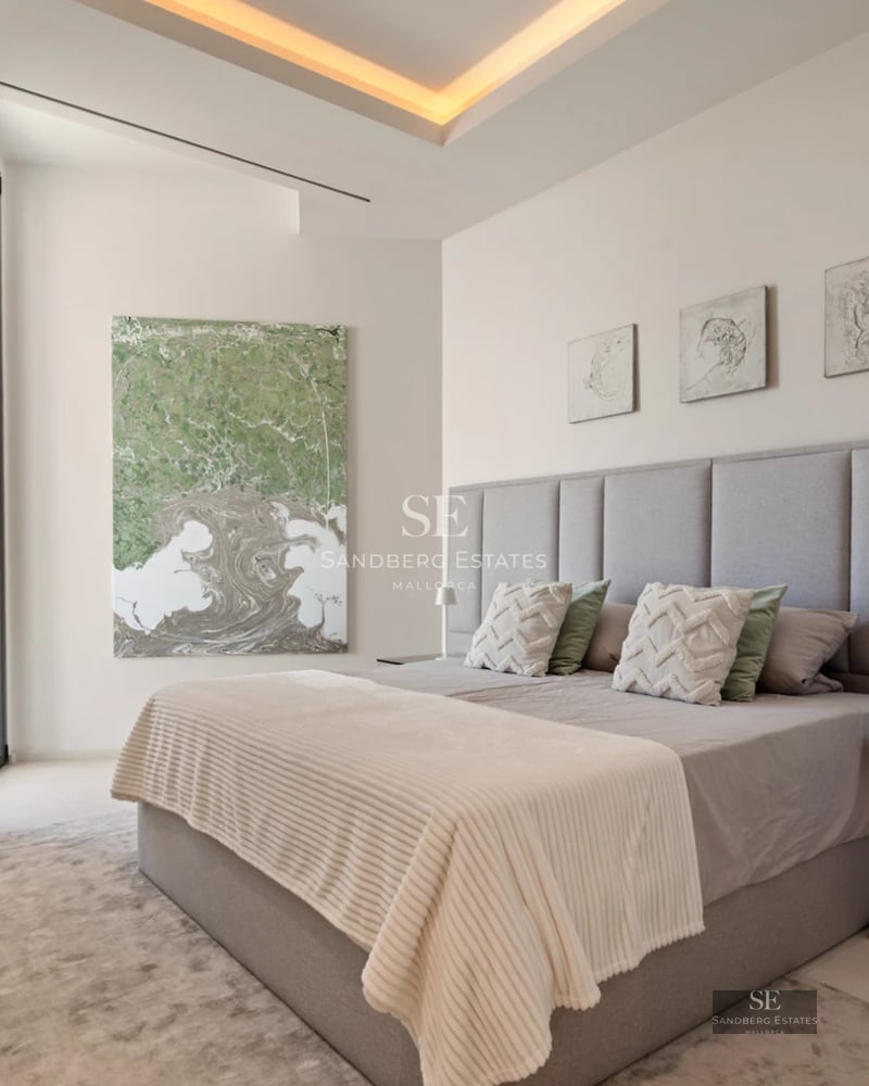 Exterior view of a modern villa featuring a pool, large windows, and a minimalist architectural design. Lush garden.