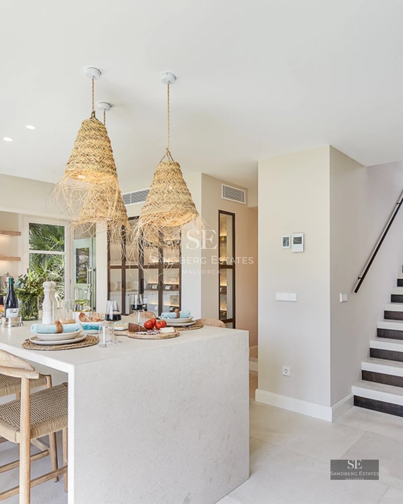 Image of a modern villa with an infinity pool, large windows, and minimalist design. Well-maintained garden and sea views.