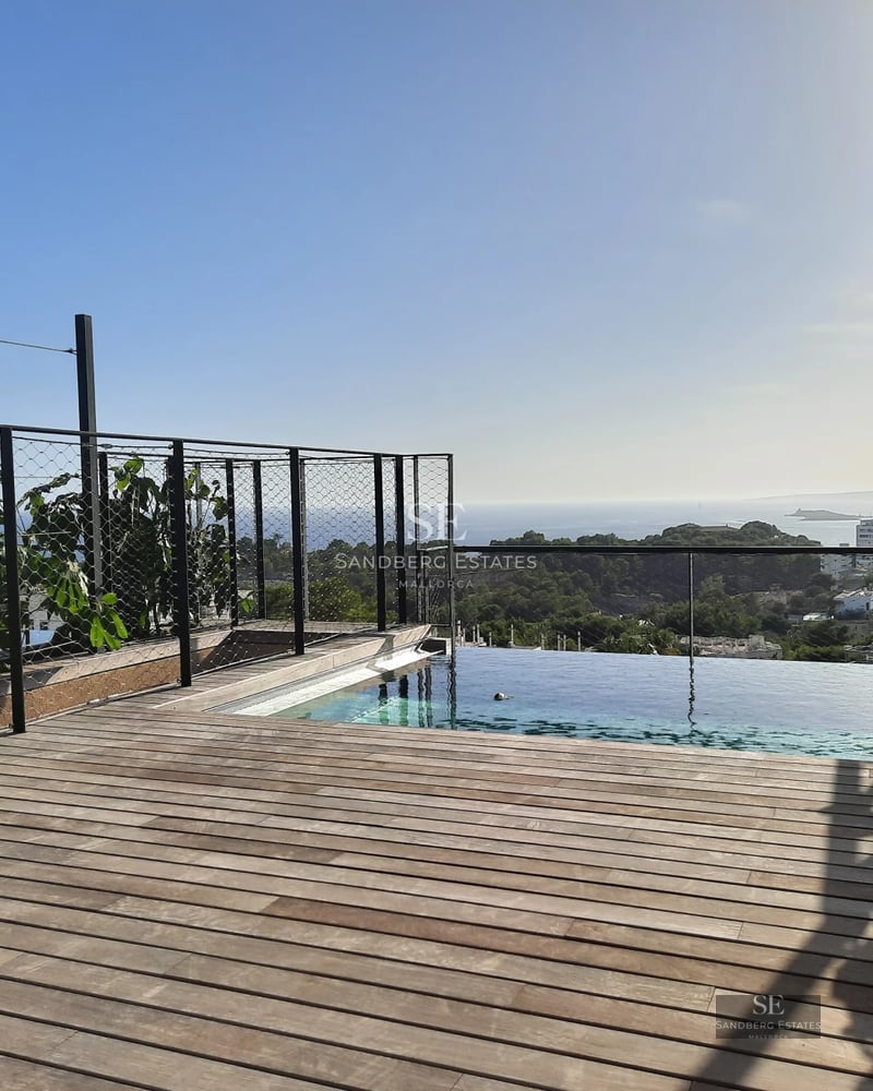 Aerial view of a modern villa with turquoise pool, surrounded by gardens and terraces. Minimalist and elegant architectural design.