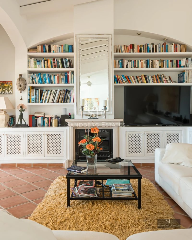 Exterior view of modern villa with infinity pool, lush garden, expansive terraces, and contemporary architectural design.