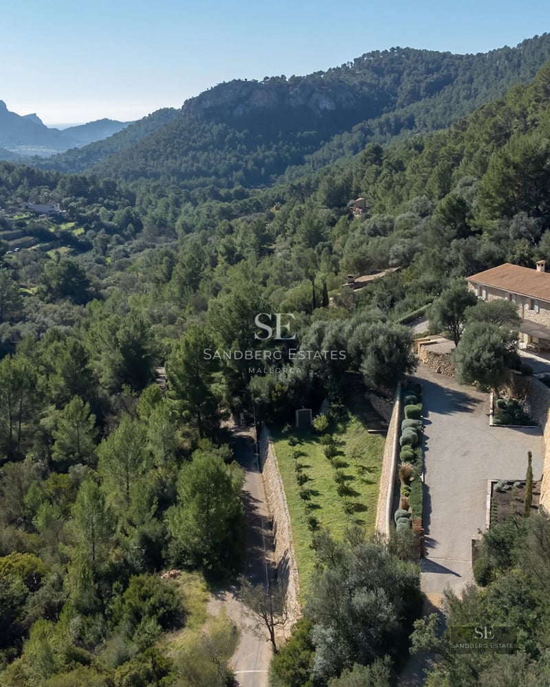 Exterior view of a luxury villa with a pool, manicured garden, and modern architecture. Minimalist design and large window panes.