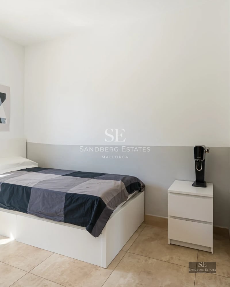 Exterior view of a modern villa with infinity pool, lush garden, and minimalist architectural design featuring large windows.