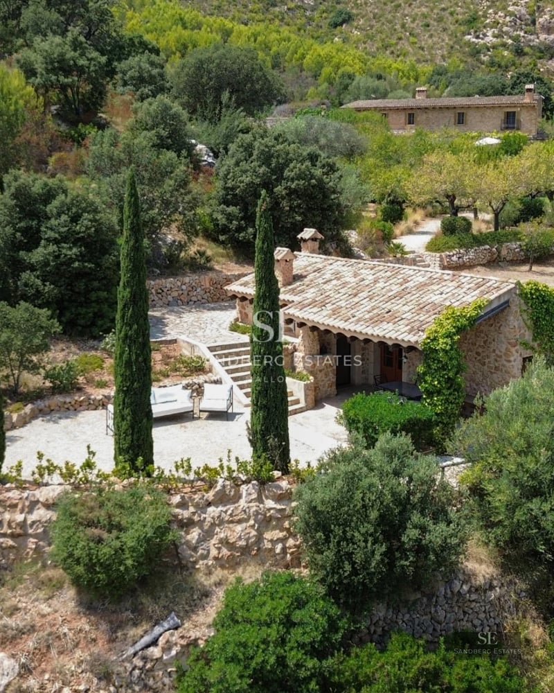 Exterior view of a modern villa featuring a swimming pool, lush garden, and sleek architecture. Contemporary design with large windows.