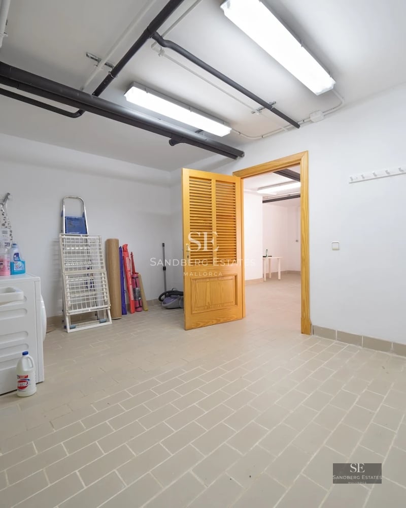 Expansive terrace with infinity pool and sea views. Modern architecture, sun loungers, and lush greenery.