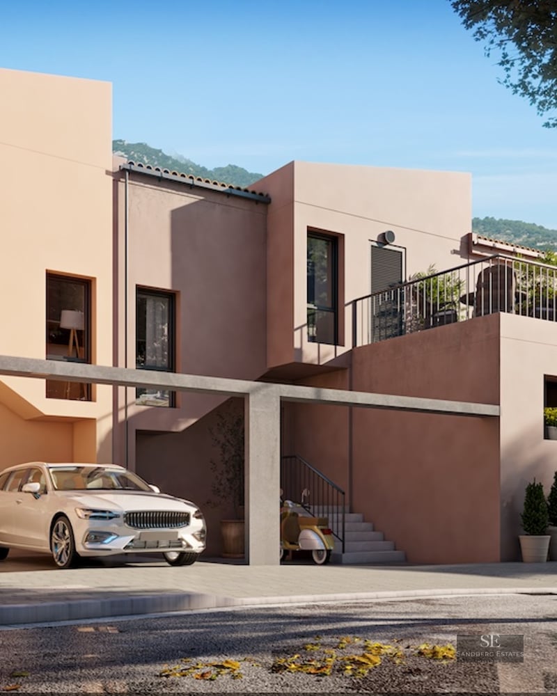 Modern multi-level home with peach-colored walls, a covered parking area with a white car, and architectural stairs.