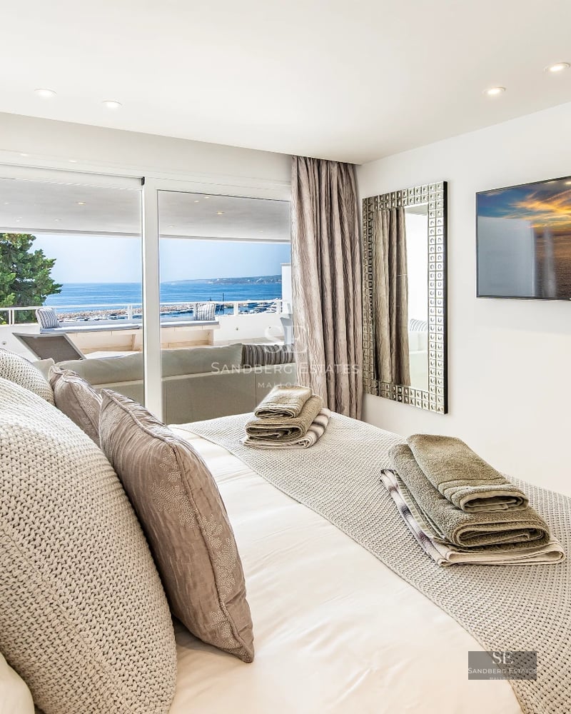 Exterior view of modern villa with pool, garden, and terrace. Large windows illuminate the architectural design. Impeccable landscaping.