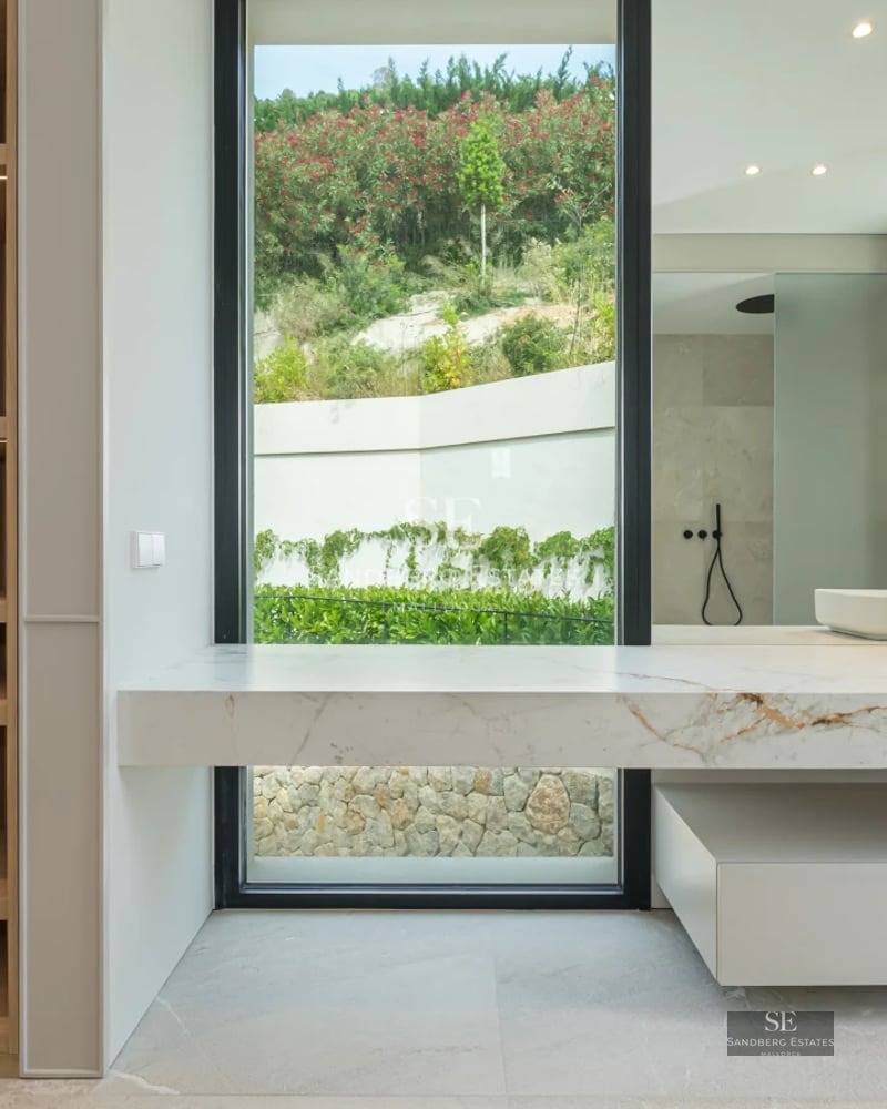 Modern penthouse with balcony, sea view, and pool. Minimalist interior, wooden floors, and abundant natural light.