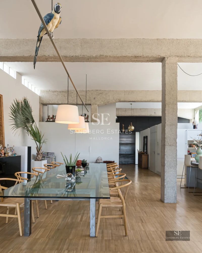 Exterior view of modern villa featuring infinity pool, large windows, and lush garden. Minimalist architecture and manicured landscaping.